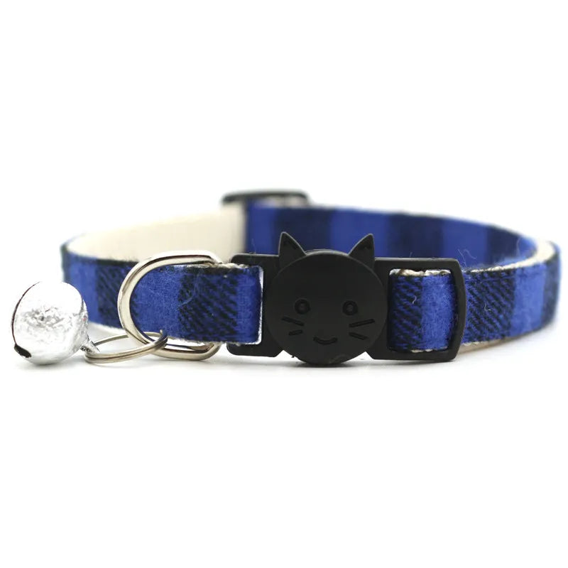 cute blue and black cat collar with a bell and a smiley cat face shape 