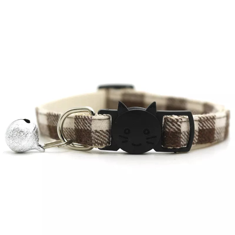 cute beige and brown cat collar with a bell and a smiley cat face shape 