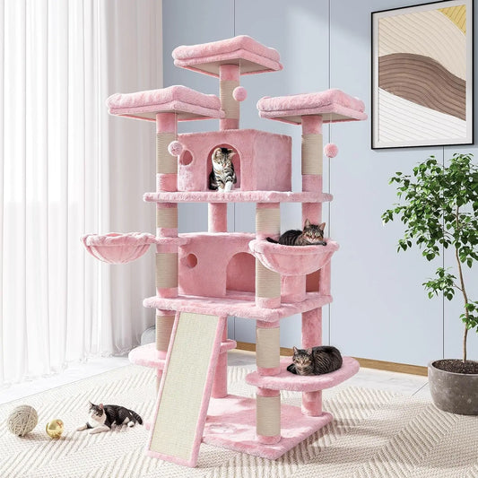 a huge pink cat castle with 4 cats sleeping and sitting on it and playing around it