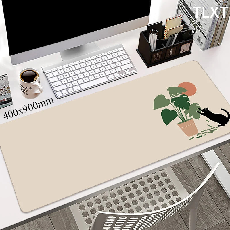 white computer desk with a very cute rectangular keypad and a drawing of a black cat playing with the pant pot