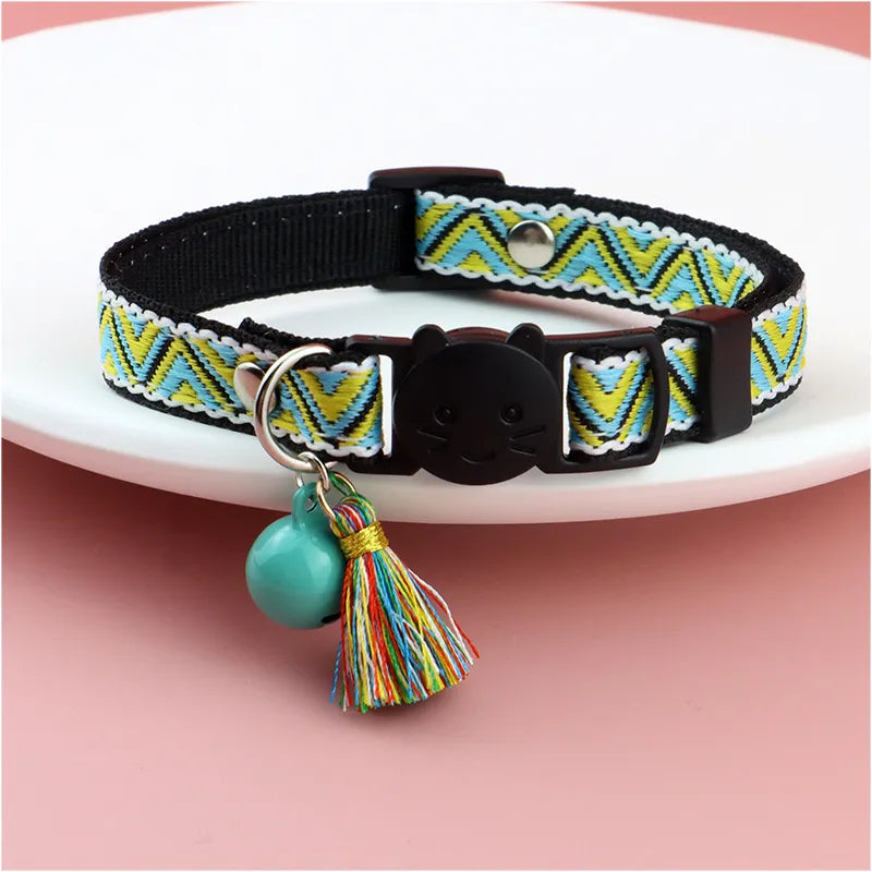 a green striped colorful color with a cat face for cats with a jingle bell on it