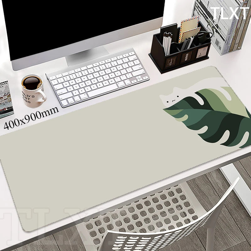 white computer desk with a very cute light green rectangular keypad with drawing of a green leaf coming out the side 