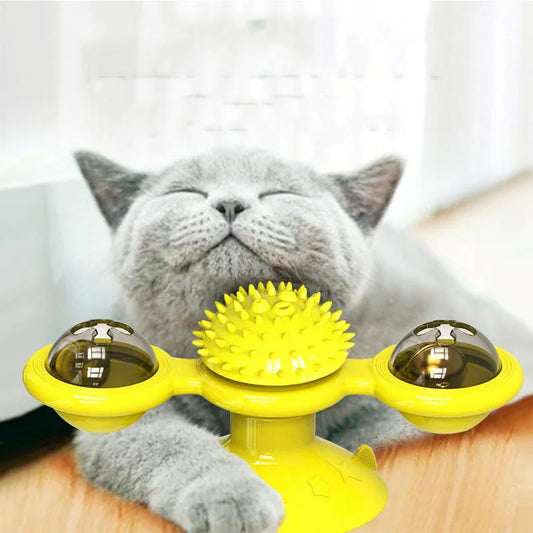 a cute gray cat scratching on a yellow cat toy 