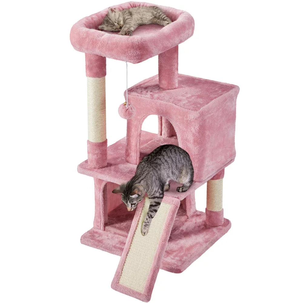 a pink cat tower tree stand with two cats using it, one cat is sleeping and the other jumping 