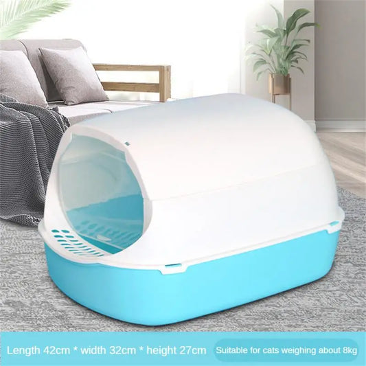a light blue and white cat toilet litter box in front of a gray couch 